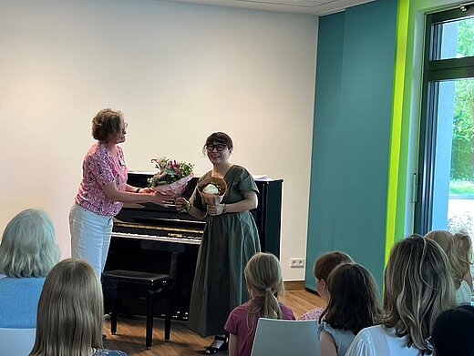 Elisabeth Siemer, die Leiterin des Friederike Fliedner Hospizes Kaiserswerth, bedankt sich nach dem Konzert mit einem Blumenstrauß bei der Künstlerin Hajime Umetani für das eindrucksvolle Konzert.